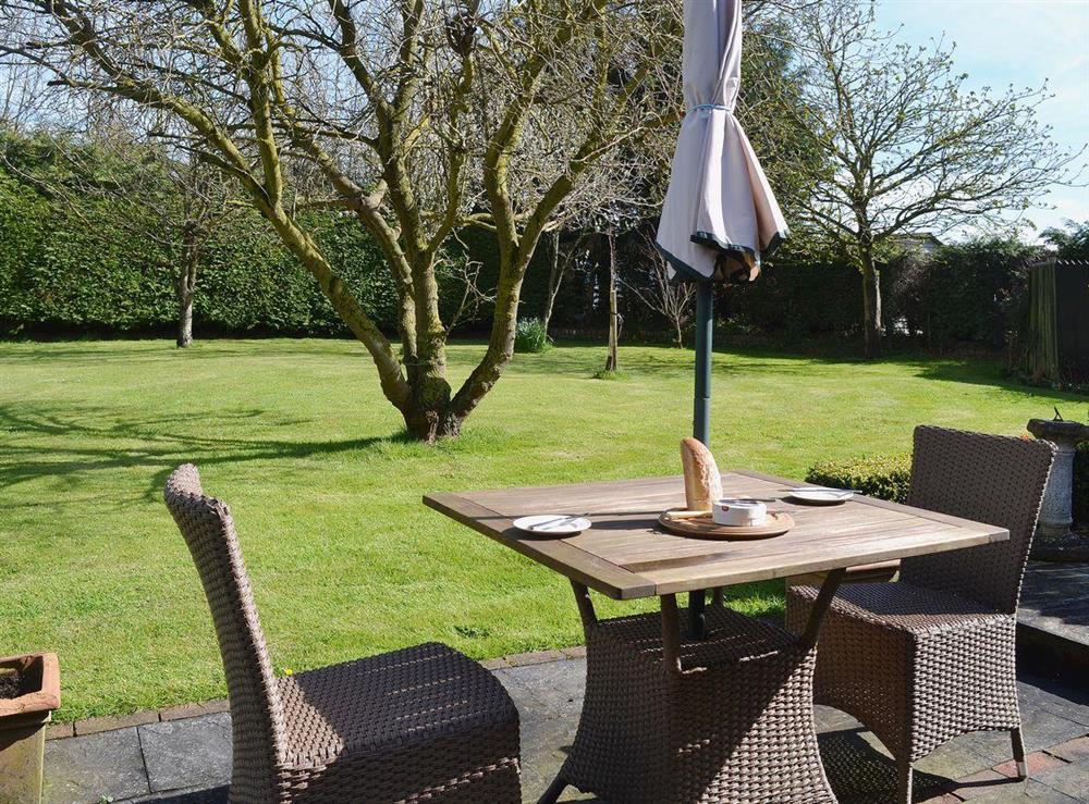 The conveniently placed table and chairs in the garden make an ideal spot for an el fresco meal at The Stables, 