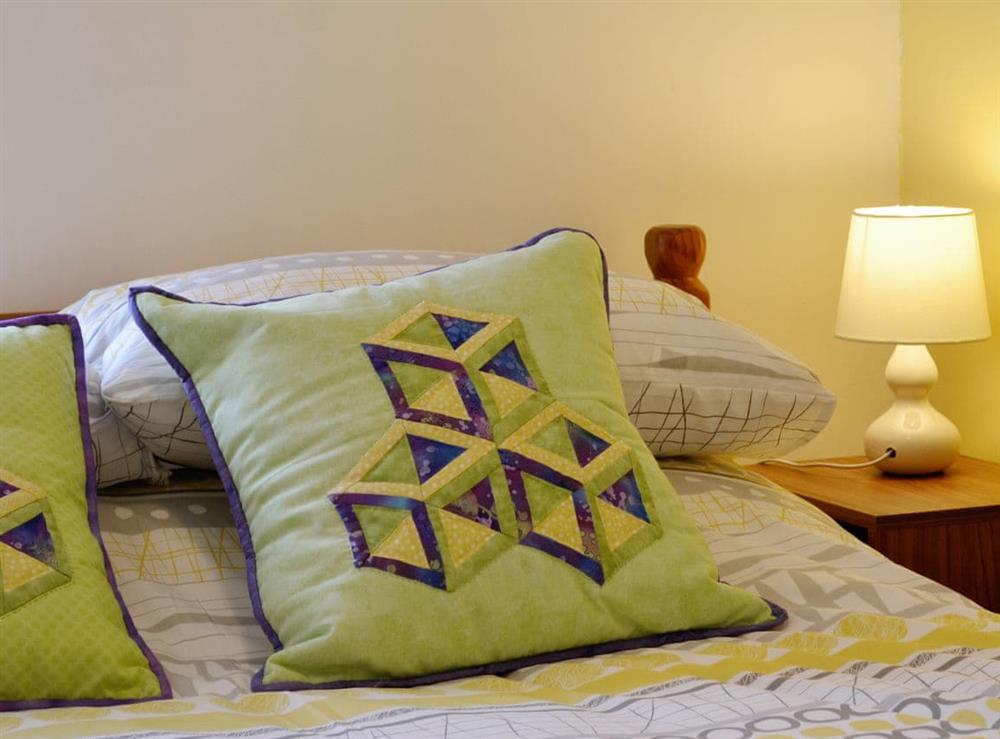 The bedroom is furnished with astylish soft furnishings at Capel Fawnog Bach in Talsarnau, Gwynedd