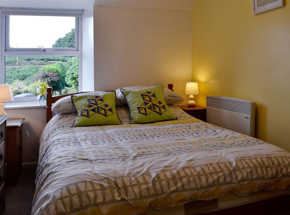 The double bedroom is cosy and romantic at Capel Fawnog Bach in Talsarnau, Gwynedd