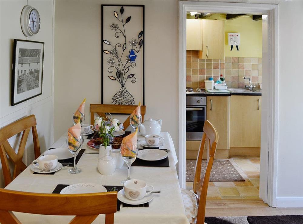 The stylish dining area is adjacent to the kitchen at Capel Fawnog Bach in Talsarnau, Gwynedd