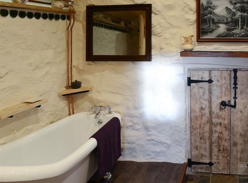 Double bedroom with romantic standalone claw foot bath at Capercaillie Cottage in Rhilochan, Rogart, near Dornoch, Highlands, Sutherland