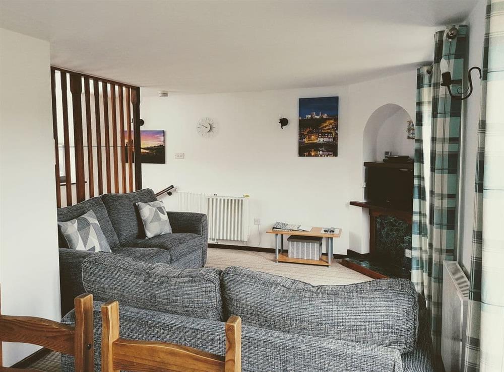 Living room with dining area at Capstan Cottage in Whitby, Yorkshire, North Yorkshire