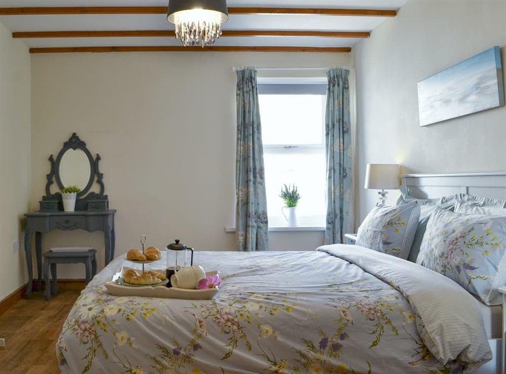 Double bedroom with beamed ceiling at Captains Cottage in Allonby, near Maryport, Cumbria