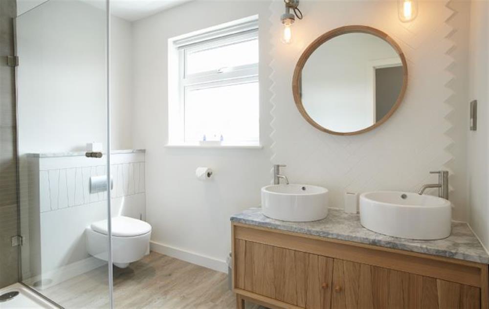 En-suite bathroom to master bedroom with twin basins all bathrooms are renovated to a high standard stylish and practical with a coastal feel