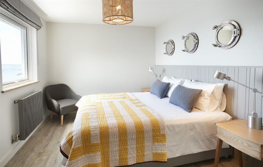 Fifth bedroom with king size bed and large wall length headboard at Captains House, Marazion