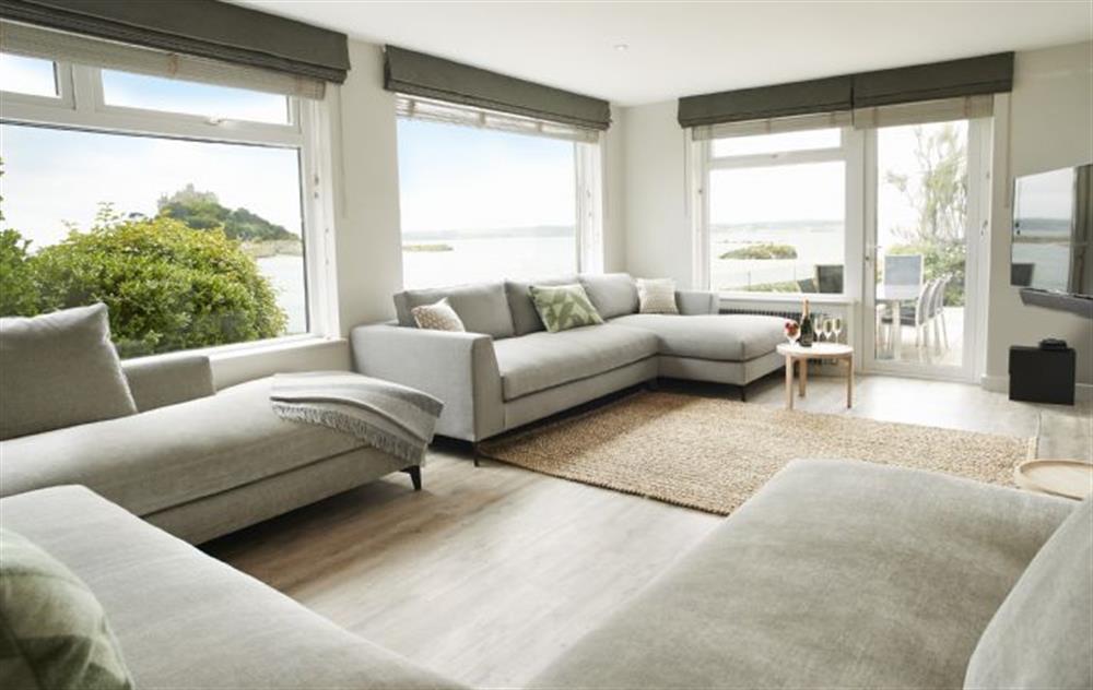 Sitting room is renovated to a high standard and all furniture is styled in a classic colour scheme soft furnishings are in warm coastal accent tones all selected by an Interior Designer with spectacular views opening onto outdoor dining area