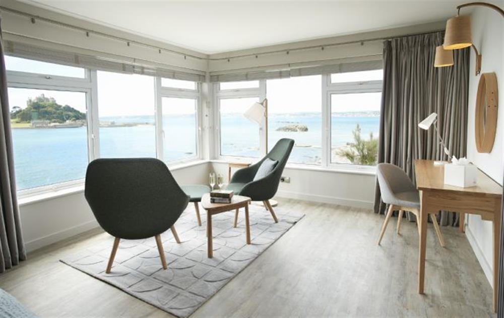 The master bedroom interior design is stylish and fresh with light oak furniture and an accent of warm coastal tones relax and admire the view across to St Michael’s Mount from the master bedroom