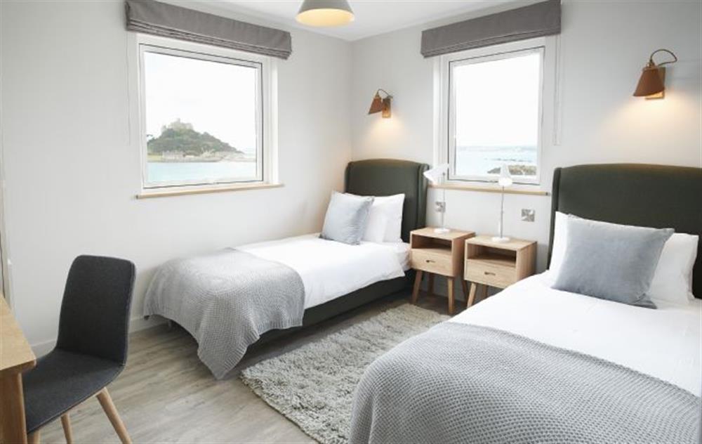 Twin bedroom with 180 degree sea views the bedroom interior design is stylish and fresh with light oak furniture and an accent of warm coastal tones