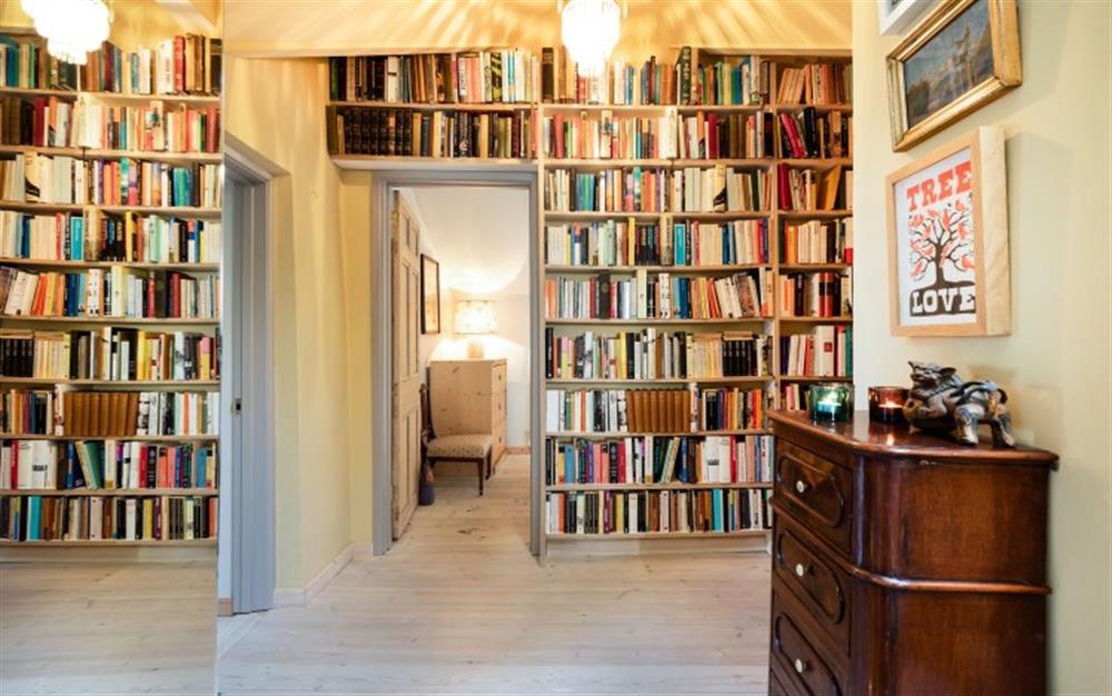 There are built-in bookshelves in the upstairs landing. at Carabone Cottage in The Lizard
