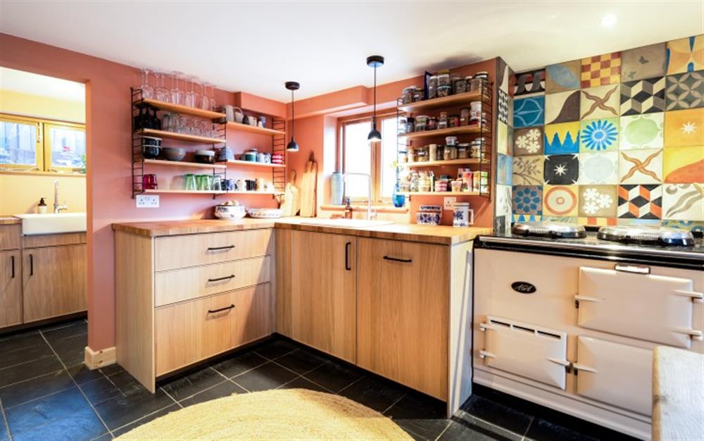 Underneath those striking handmade tiles, there's an Aga for your holiday cooking and baking. at Carabone Cottage in The Lizard