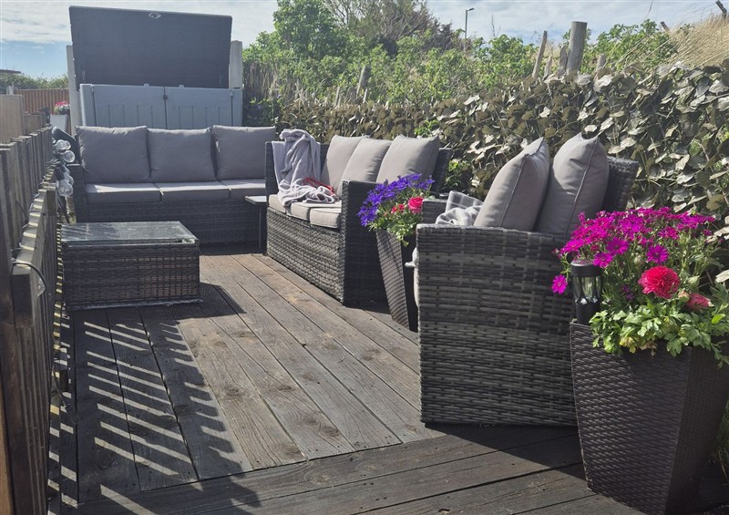 Enjoy a glass of wine on the patio at Caravan 596, Prestatyn