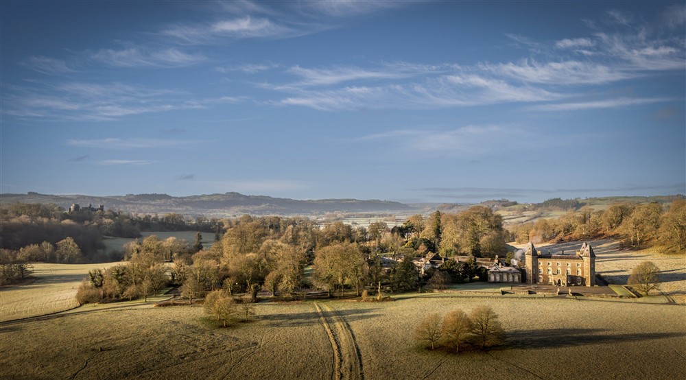 An aerial view of Dinefwr, with Newton House on the right and Dinefwr Castle in the background on the left, Carmarthenshire at Cariad Cottage in Llandeilo, Carmarthenshire