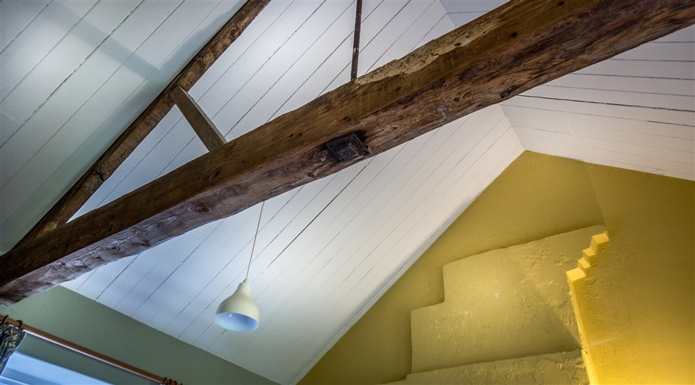 The vaulted ceiling and exposed beams in the living space at Cariad Cottage in Llandeilo, Carmarthenshire