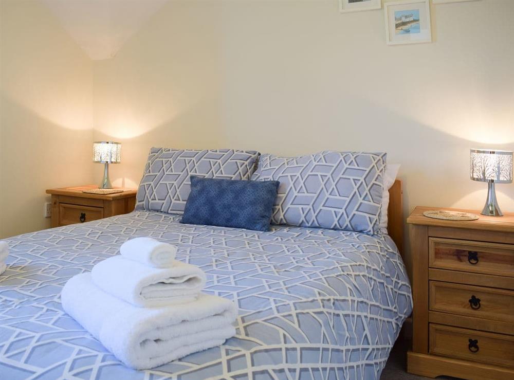 Comfortable bedroom boasting a kingsize bed at Carmarthen Cottages- Barn Cottage in Cwmdu, near Carmarthen, Dyfed