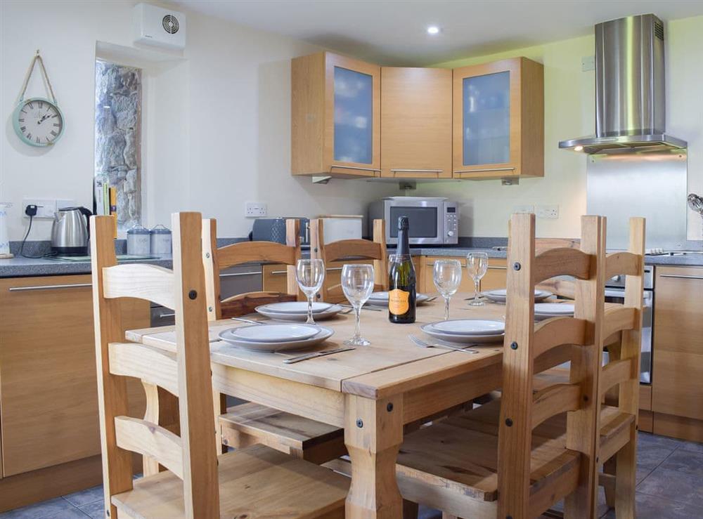 Farmhouse style dining table and chairs in the kitchen at Carmarthen Cottages- Barn Cottage in Cwmdu, near Carmarthen, Dyfed