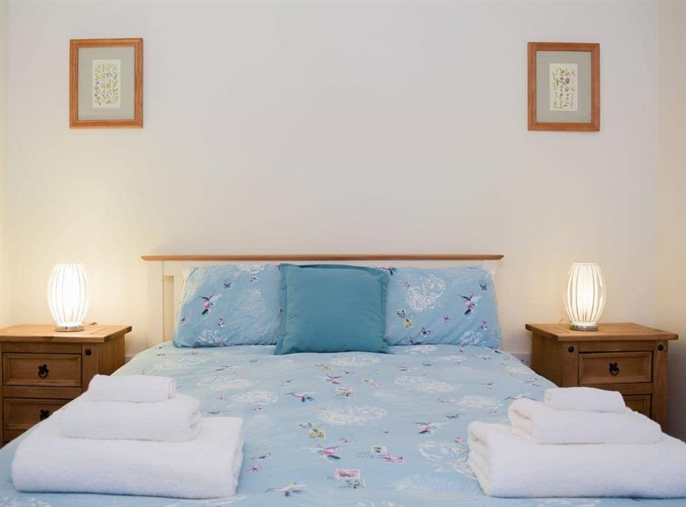 Welcoming bedroom with kingsize bed at Dairy Cottage, 