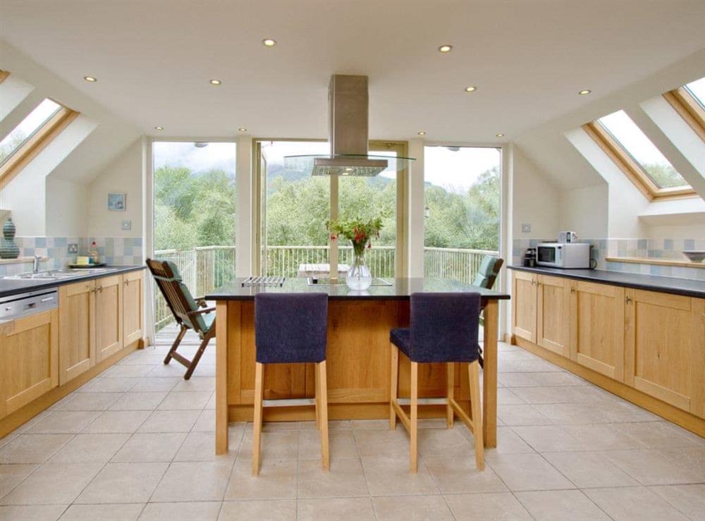 Spacious and well-equipped kitchen area with French doors onto the balcony at Carness West in West Carness, By Fort William., Inverness-Shire