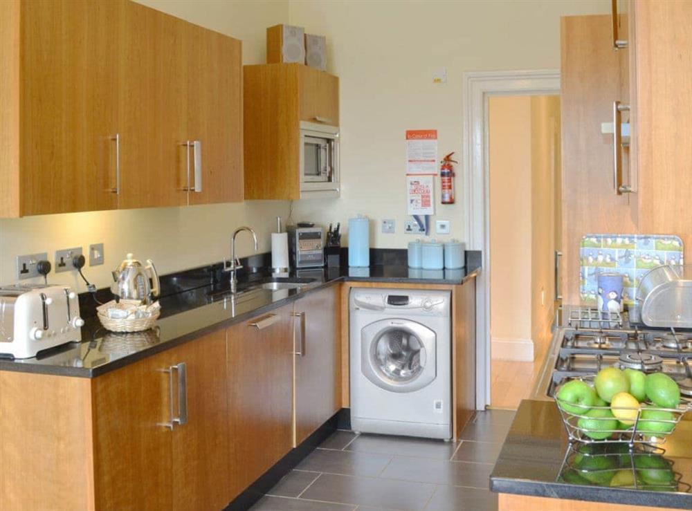 Kitchen with granite worktops and dining area with tiled floor at One Acre View, 