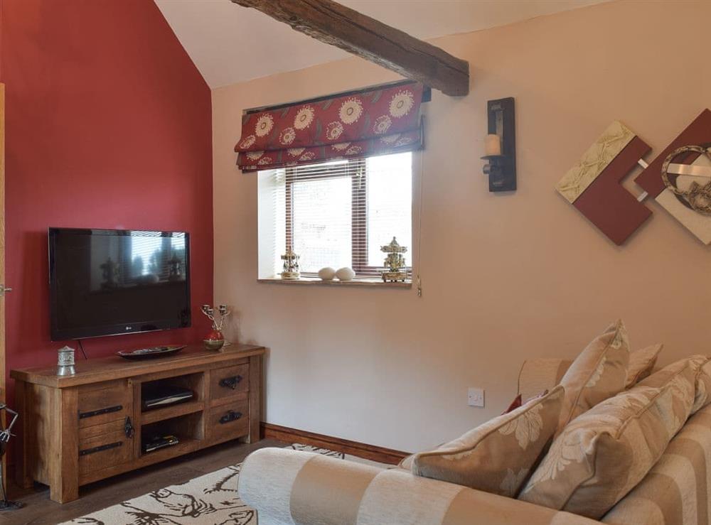 Cosy living / dining room with TV at Carousel Cottage in Cantley, near Norwich, Norfolk