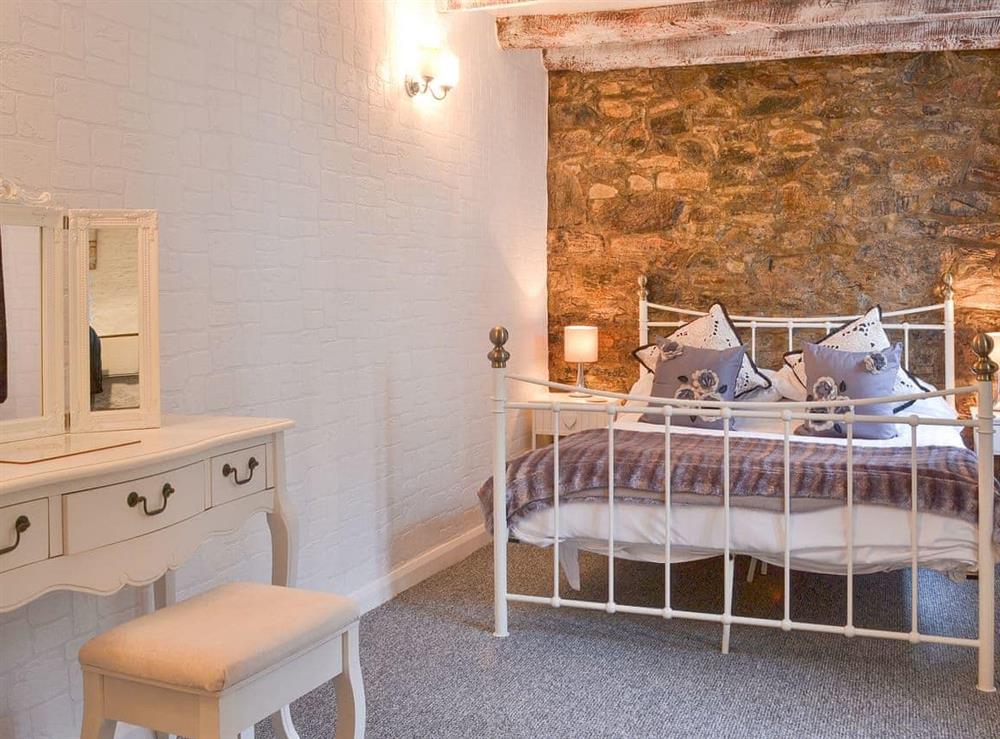 Lovely double bedroom with exposed stone wall at Carpenters in Liskeard, Cornwall