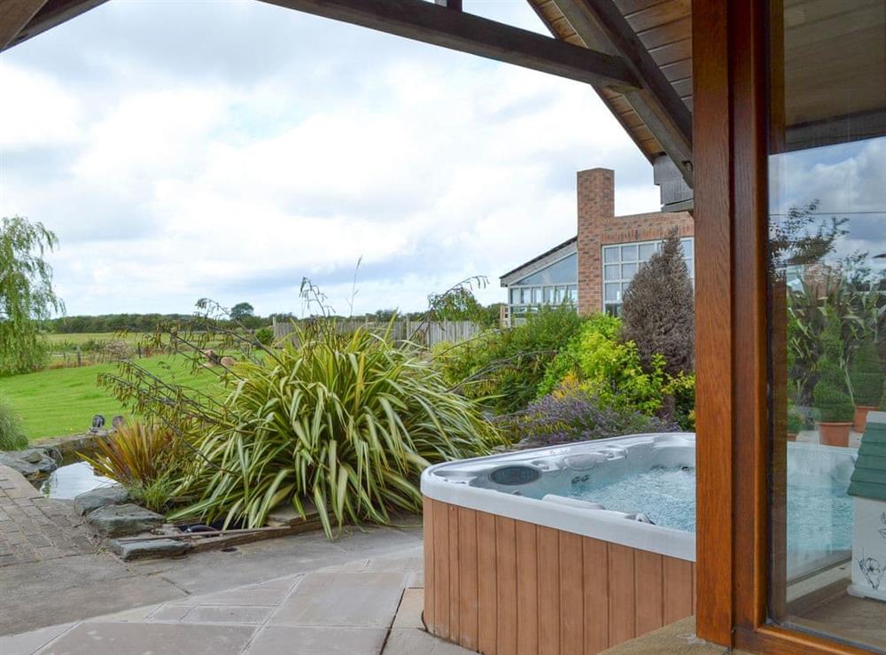 Patio area with hot tub at Carr End Barn A in Stalmine, near Poulton-le-Flyde, Lancashire