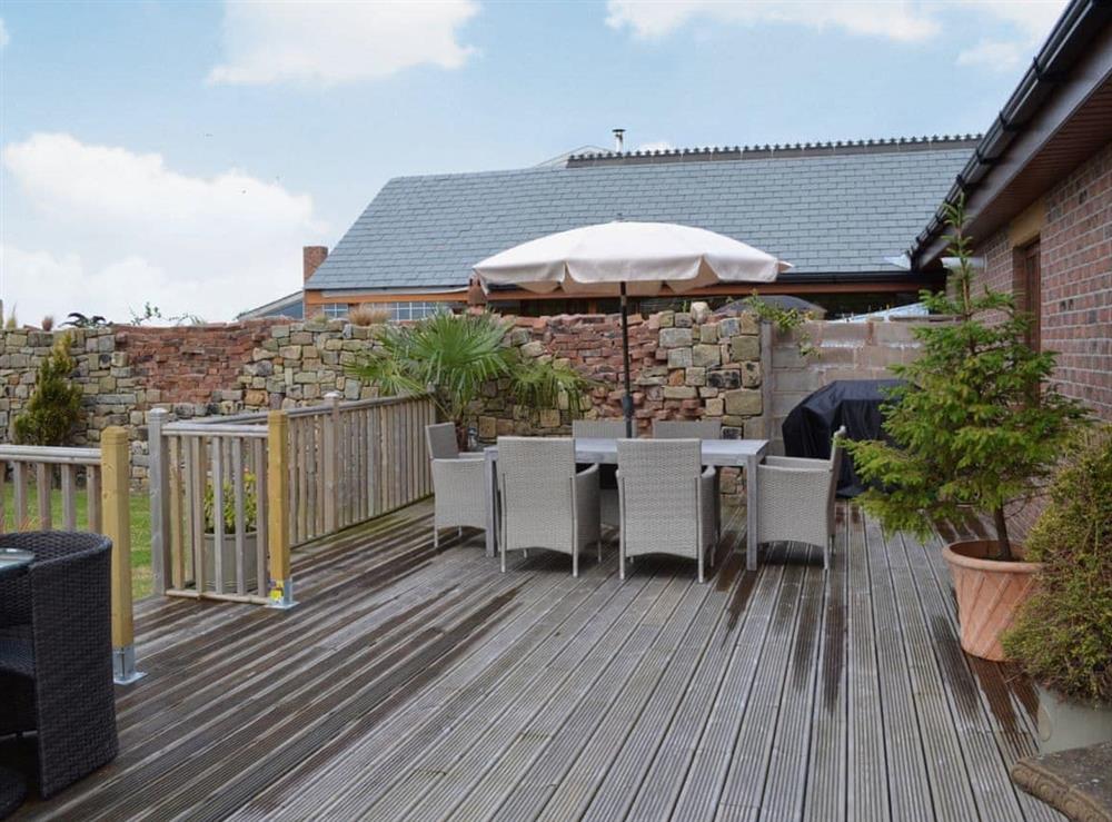 Enjoy the lovely views from the decked patio at Carr End Barn in Stalmine, near Poulton-le-Fylde, Lancashire