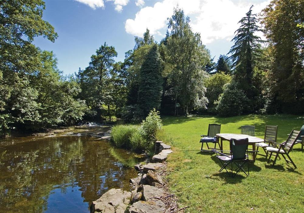 Shared gardens and river at Carriage House in Bedale, North Yorkshire