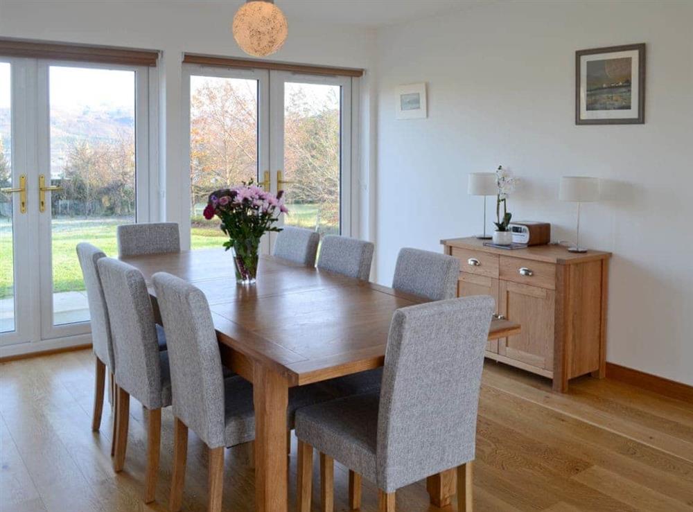 Dining area with French doors leading to garden at Carron House in Slumbay, near Lochcarron, Ross-Shire