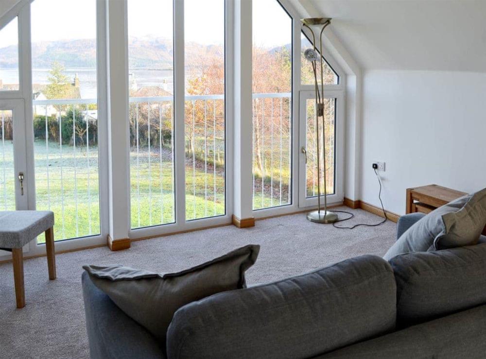 Living area with large picture windows at Carron House in Slumbay, near Lochcarron, Ross-Shire