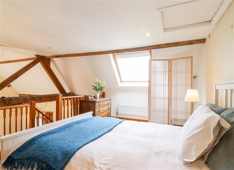 A bedroom in Cart Wheel Cottage at Cart Wheel Cottage, Steeple Bumpstead