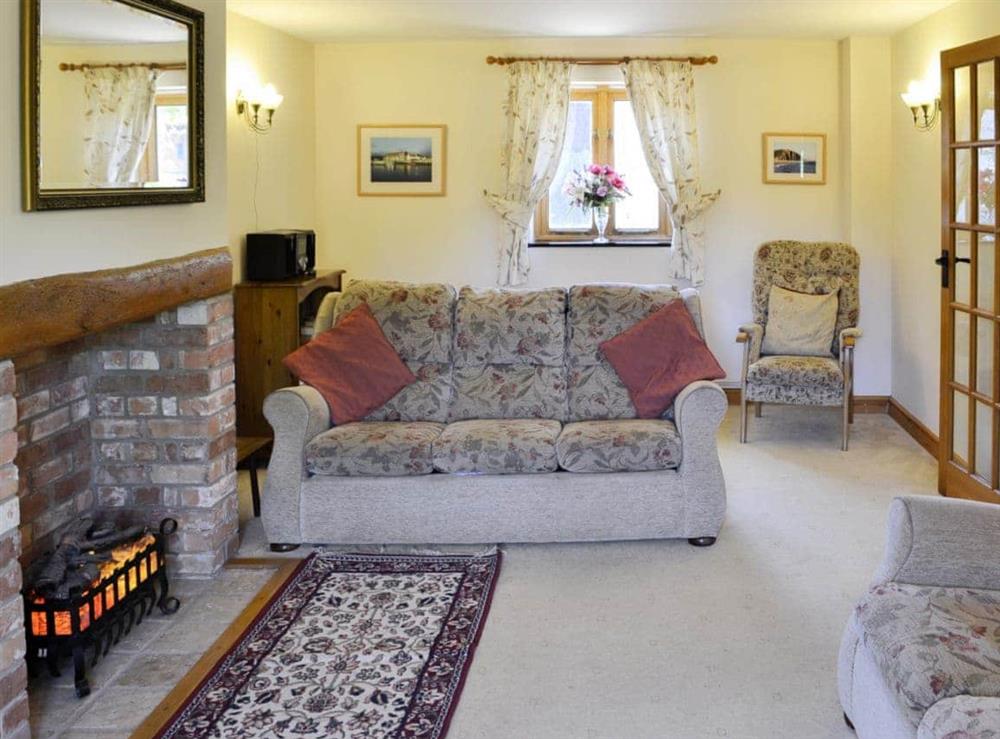 Lovely living room with feature fireplace at Carters Cottage in Puncknowle, Dorchester., Dorset