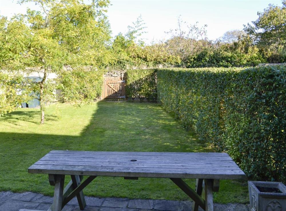 Paved patio with picnic style seating at Carters Cottage in Puncknowle, Dorchester., Dorset