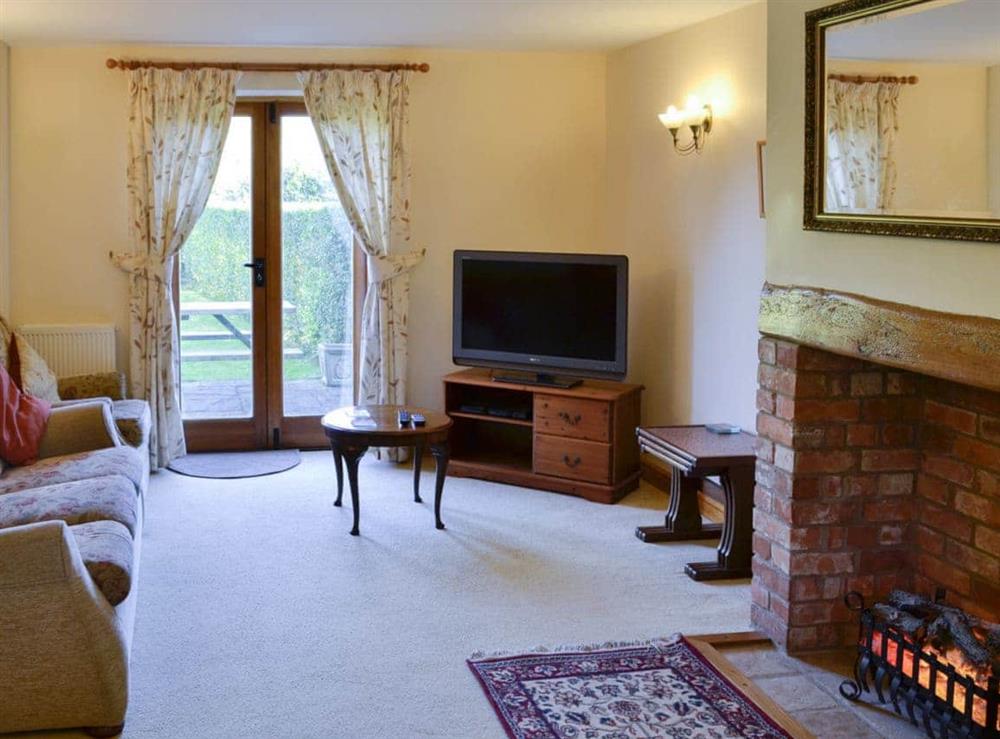 Spacious living room with access to the garden at Carters Cottage in Puncknowle, Dorchester., Dorset