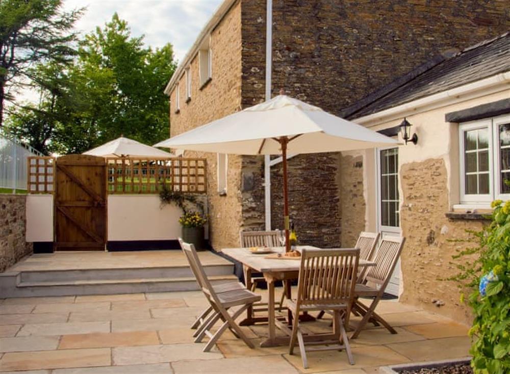 Patio with garden furniture and barbecue at Caros Cottage, 