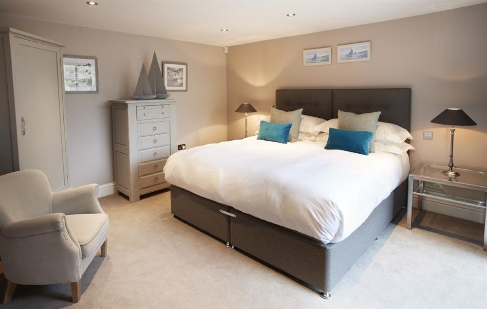 Bedroom One with 6’ super king zip/link bed and en-suite shower room at Carus House, Burneside