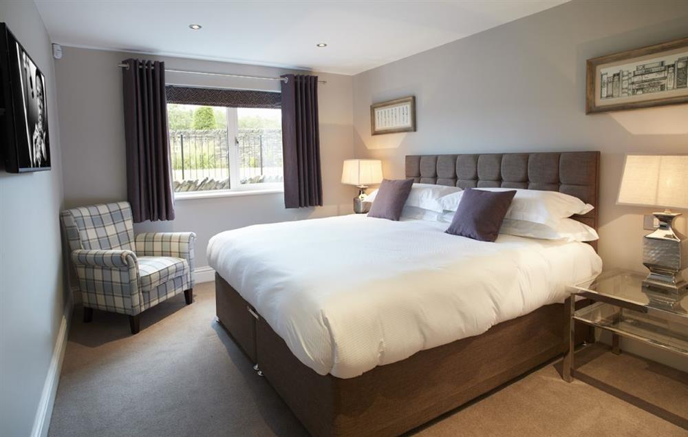 Bedroom Three with 6’ super king bed and en-suite shower room at Carus House, Burneside