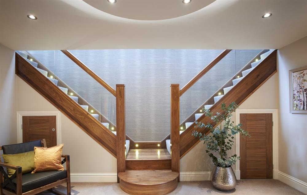Large spacious entrance hallway with dual feature staircase at Carus House, Burneside