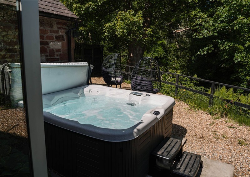 Enjoy the hot tub at Carwinley Mill House Cottage, Carwinley near Longtown