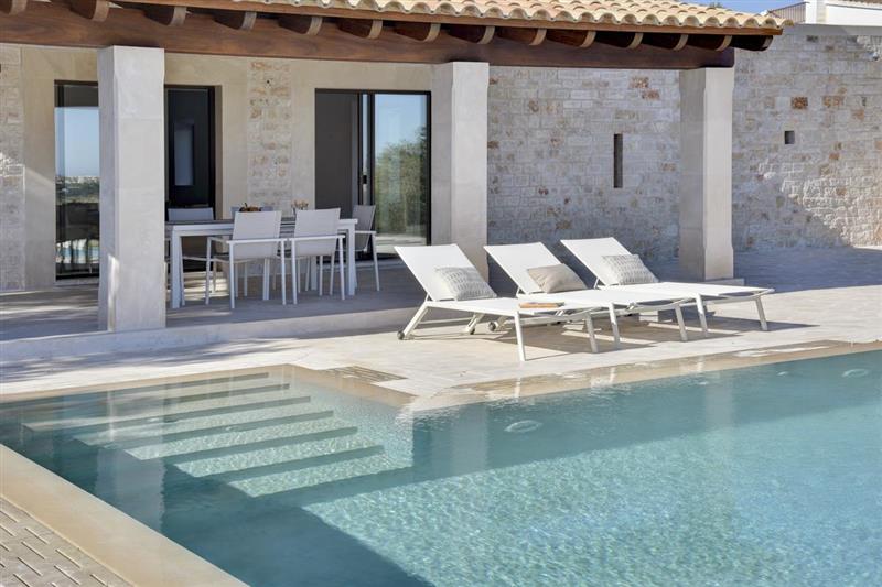 Pool and sun loungers at Casa Colom, Cala dOr, Spain