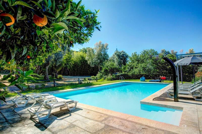 Swimming pool and sun loungers at Casa dos Fernandos, Braga area, Portugal