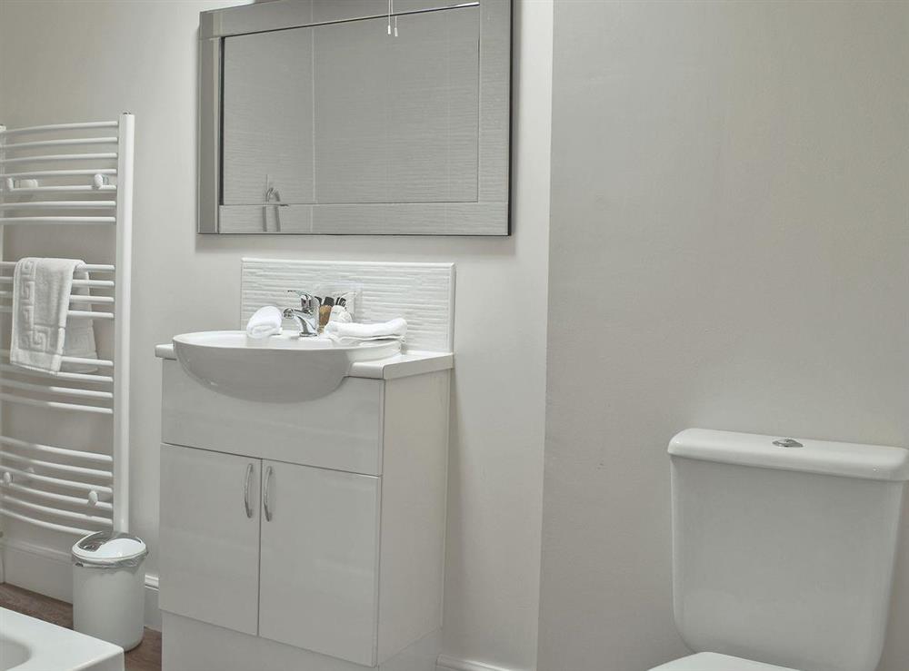 Contemporary styled bathroom with bath (over bath shower attachment), separate shower cubicle and toilet at Casa Duran in Killin, Sterlingshire, Perthshire