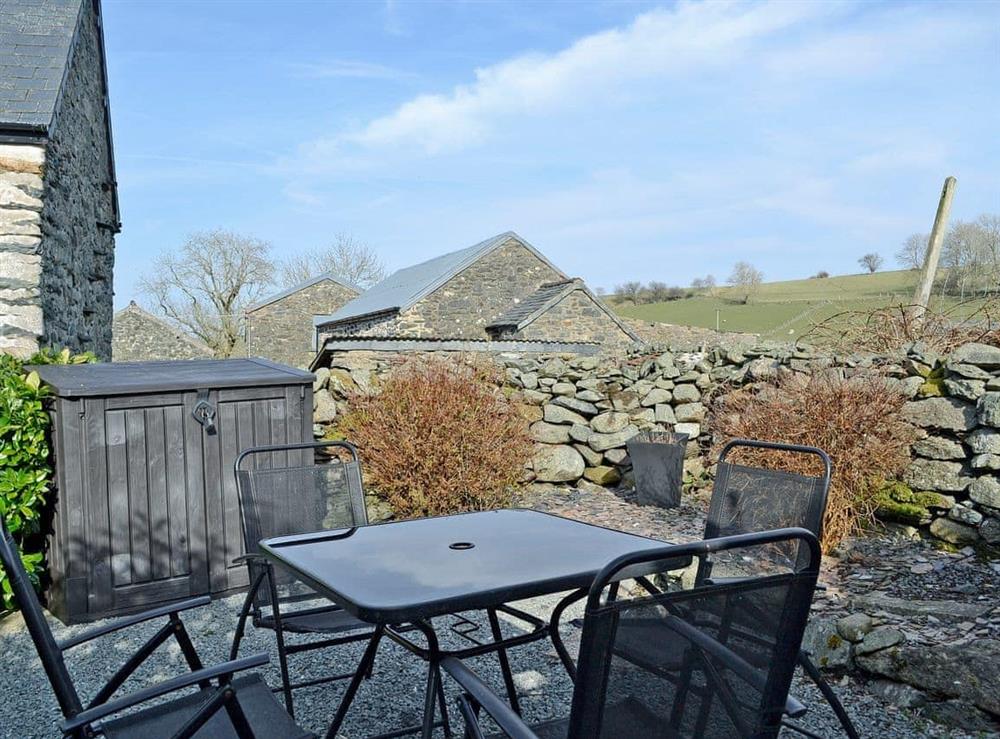 Relaxing enclosed patio with garden furniture at Castiel Cottage in Ysbyty Ifan, near Betws-y-Coed, Gwynedd