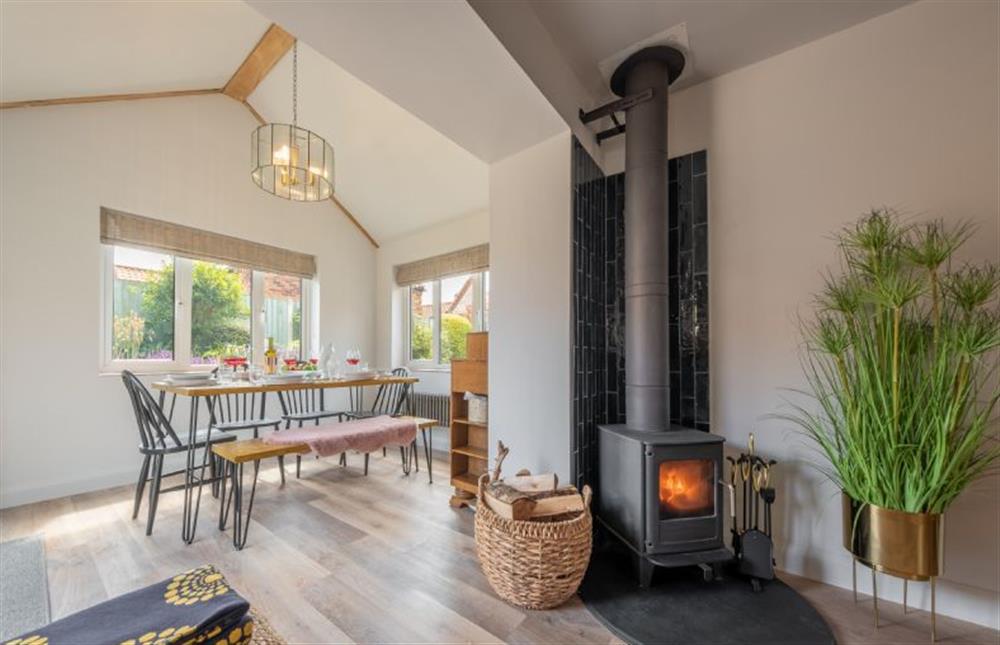 Ground floor: A cosy wood-burning stove in the open-plan living area at Castle Bungalow, Thornham near Hunstanton