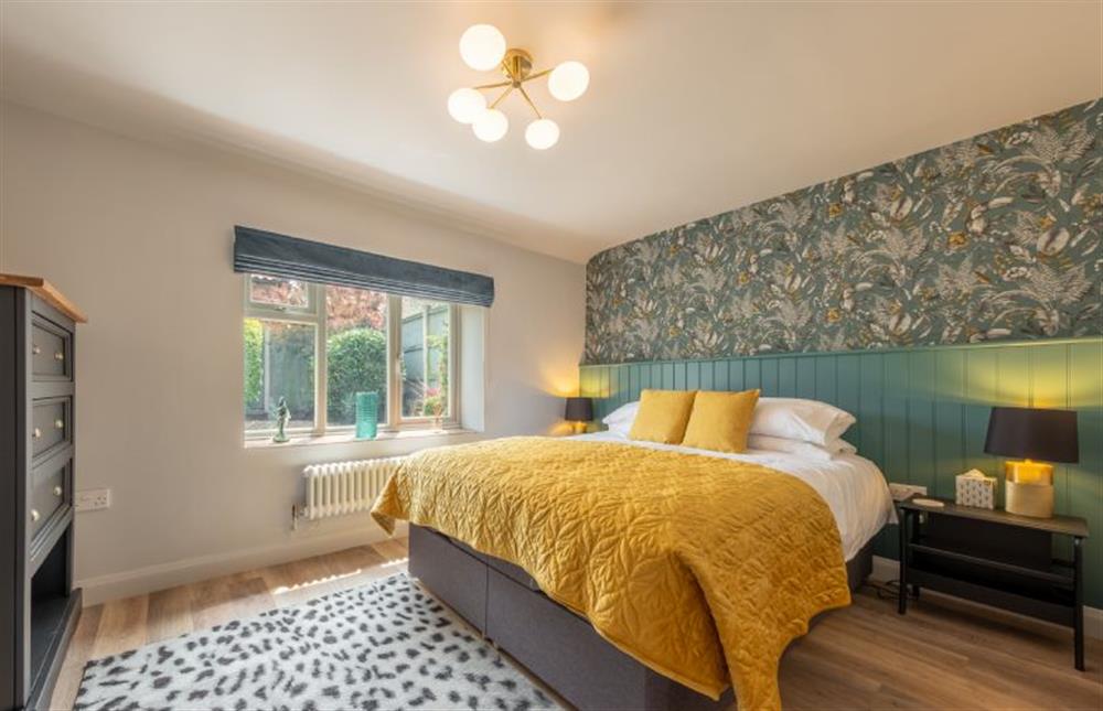 Ground floor: Master bedroom with en-suite at Castle Bungalow, Thornham near Hunstanton