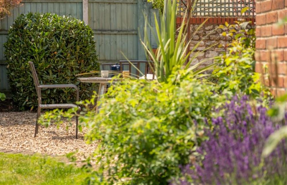 Outside: The mature rear garden with seating at Castle Bungalow, Thornham near Hunstanton
