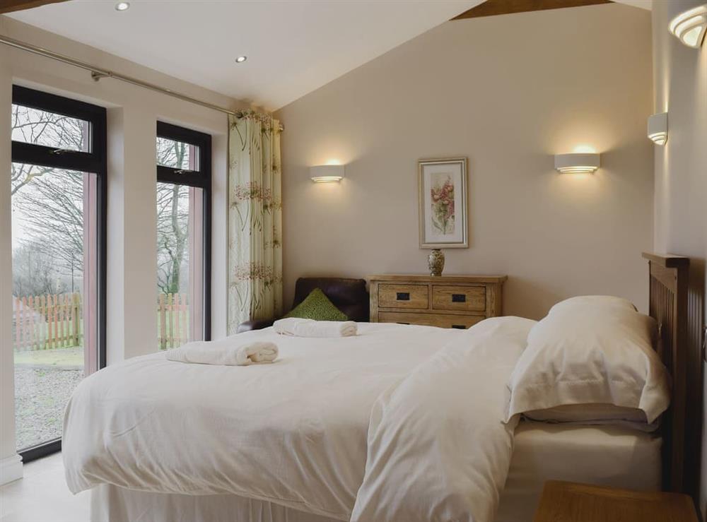 Lovingly furnished bedroom with large picture windows at Castle Farm in Tufton, near Haverfordwest, Dyfed