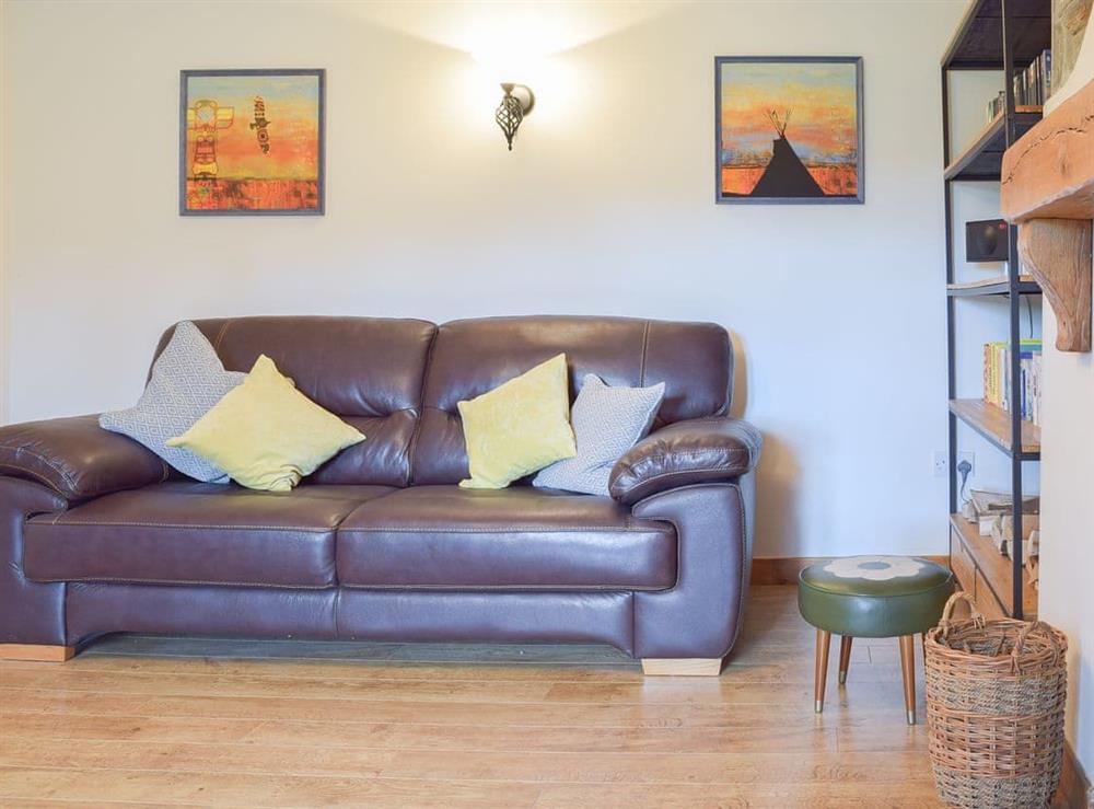 Comfortable leather furniture at Castle Hill Cottage in Llansteffan, near Carmarthen, Dyfed