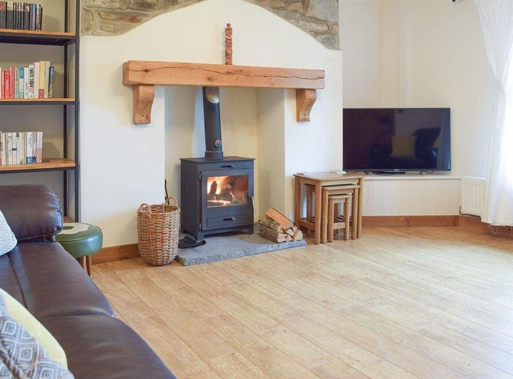 Spacious living room with feature fireplace at Castle Hill Cottage in Llansteffan, near Carmarthen, Dyfed