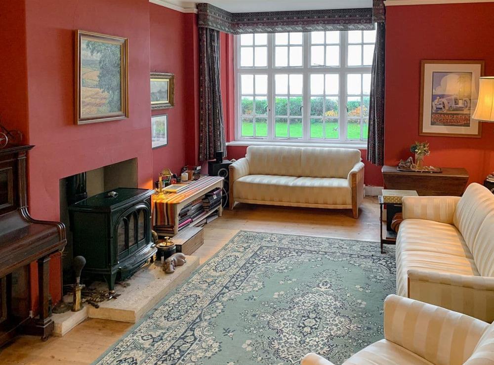 Charming living room with wood burner at Castle Hill House in Sidbury, near Sidmouth, Devon