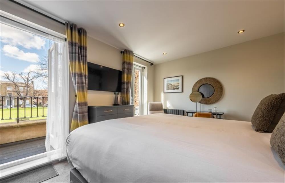 Castle House: Master bedroom has access to the balcony overlooking the Buttlands at Castle House, Wells-next-the-Sea